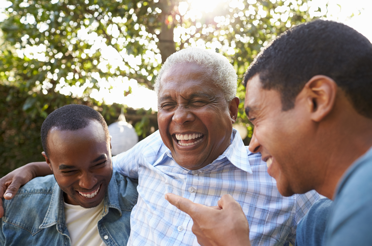 Three men laughing and hugging